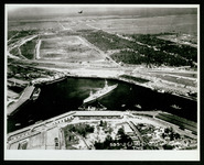 USS Houston (CA-30) in Houston Ship Channel, at the turning basin with aerial photographer above, taken from the air