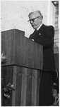 Hugh Roy Cullen standing at a podium