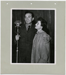 Vic Damone and Jo Ann Breneks stand at KUHF-FM microphone