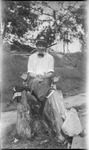 Young man sitting on a tree stump