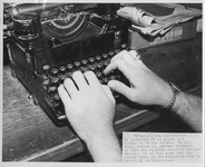 Close up off a student using a typewriter