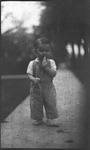 Boy standing on sidewalk