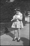 Girl holding doll