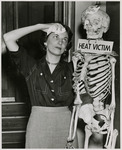 Madge Christian poses with a skeleton