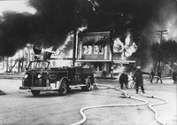 Firefighters fighting Farrar lumber yard fire with fire engine 7