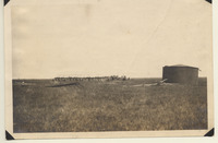 Oil tank, dredge pipe, pontoons north of Texas City terminal tracks