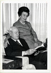 W. B. Bates sitting in a chair next to Mrs. Bates