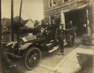 Firefighters on fire engine in front of Fire Station 4