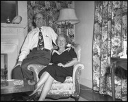 Man and smiling woman on a chair