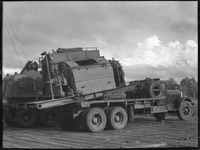 Two trucks carrying machinery