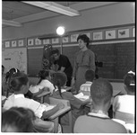 Teacher stands in front of classroom as Paul Schlessinger films students
