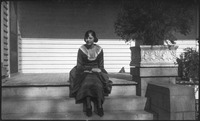 Woman sitting at the top of steps