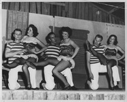 Students perform can-can on stage