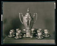 Photograph of coffee urn and cups from the ship’s silver service, which was presented by the people of the city of Houston