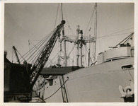 Crane loading vehicle onto ship