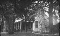 Side view of house surrounded by trees