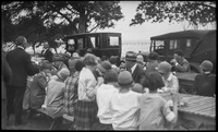Group of people sitting at wooden tables