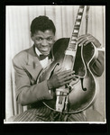 Clarence "Gatemouth" Brown posing with his guitar