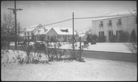Distant view of house with snow covered yard