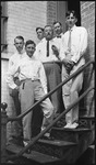 Group of men posing on steps