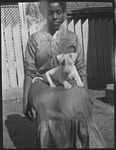 Woman sitting with dog on her lap