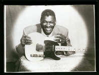 Clarence "Gatemouth" Brown posing with his guitar
