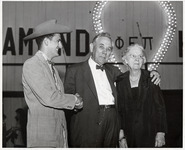 Hugh Roy Cullen standing between a man and Lillie Cranz Cullen