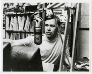 Man at microphone in KUHF studio