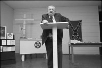 Grand Dragon standing at podium at the Ku Klux Klan Information Center