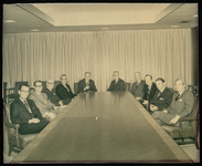 President Philip G. Hoffman with a group of men around a table