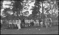 Group of people sitting on long bench