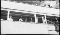Group of people looking off a boat deck
