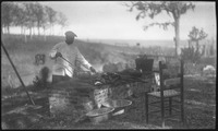 Man cooking on brick stove