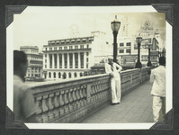 Navy sailor posing on a pedestrian bridge