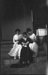 Three young women sitting on steps