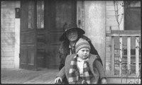 Woman and child sitting on porch