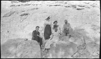 Group of people in front of a rock wall