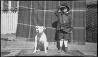 Boy saluting with dog