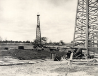 Oil derricks with horses and men