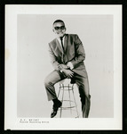 O.V. Wright seated on a bar stool.