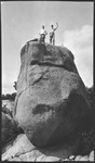 Group of men atop a large boulder