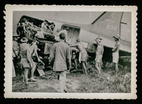 Men loading Jeep into plane, evacuation of POWs