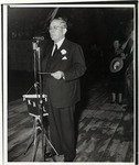 Hugh Roy Cullen standing at an outdoor microphone