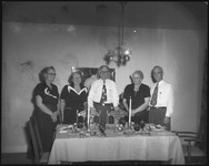 Group of people behind a dining table