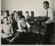 Professor using a piece of equipment to instruct the class