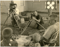 Cameramen film two boys playing checkers