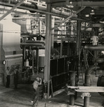 Men in overalls working with machinery