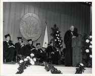 Hugh Roy Cullen standing at a podium in academic regalia