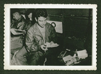 Man playing cards, evacuation of POWs