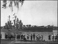 Crowd looks on as Navy ship passes by